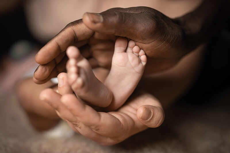 Father holding baby's feet